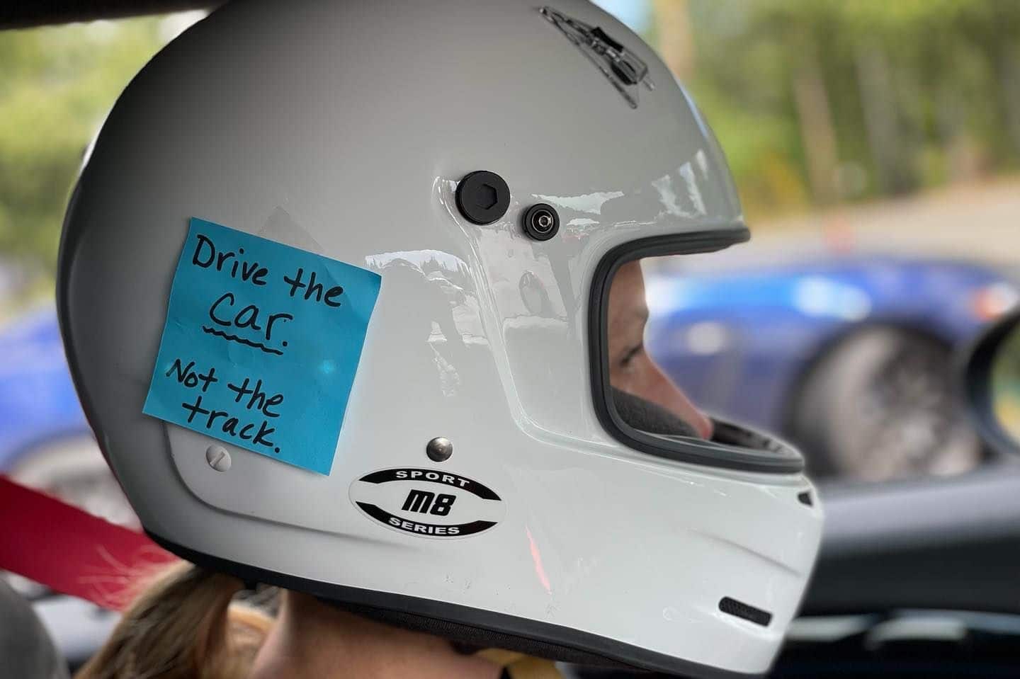Michele Graaf with post-it-note on helmet: Drive the Car, not the track
