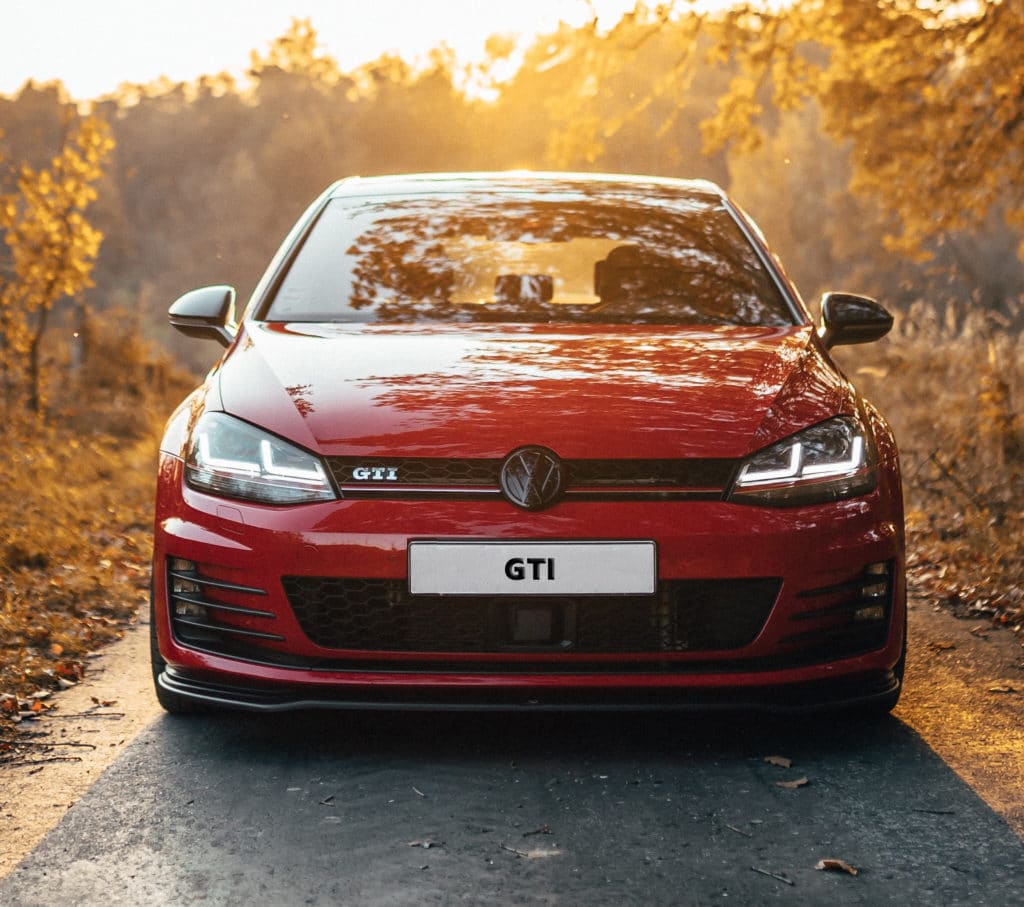 VW GTI - favorite among track cars, on road surrounded by leaves
