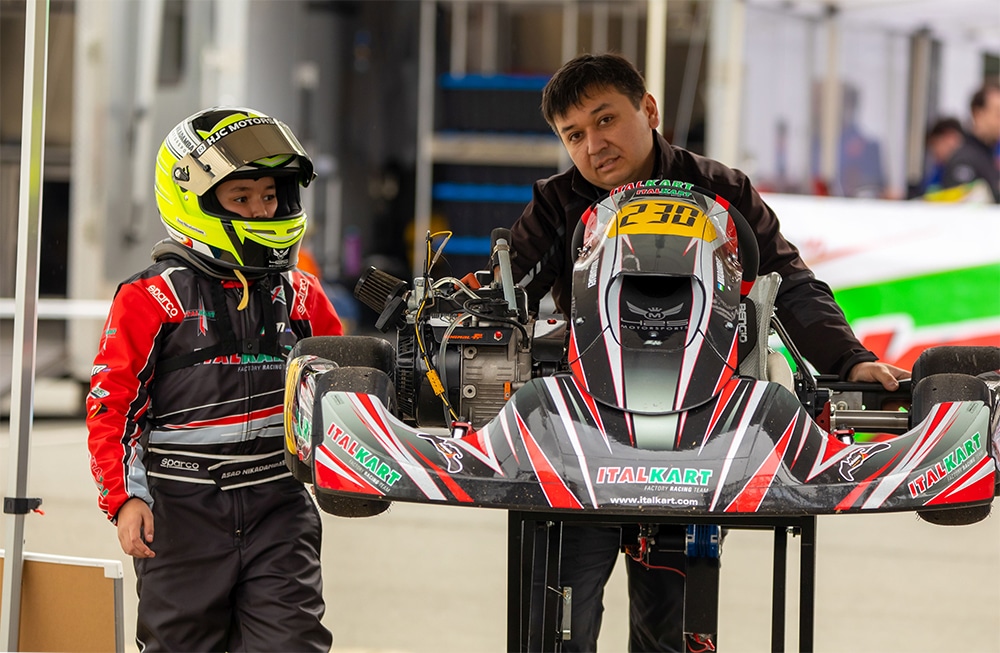 Odil and Asad Nikadambaef with kart in racing suits
