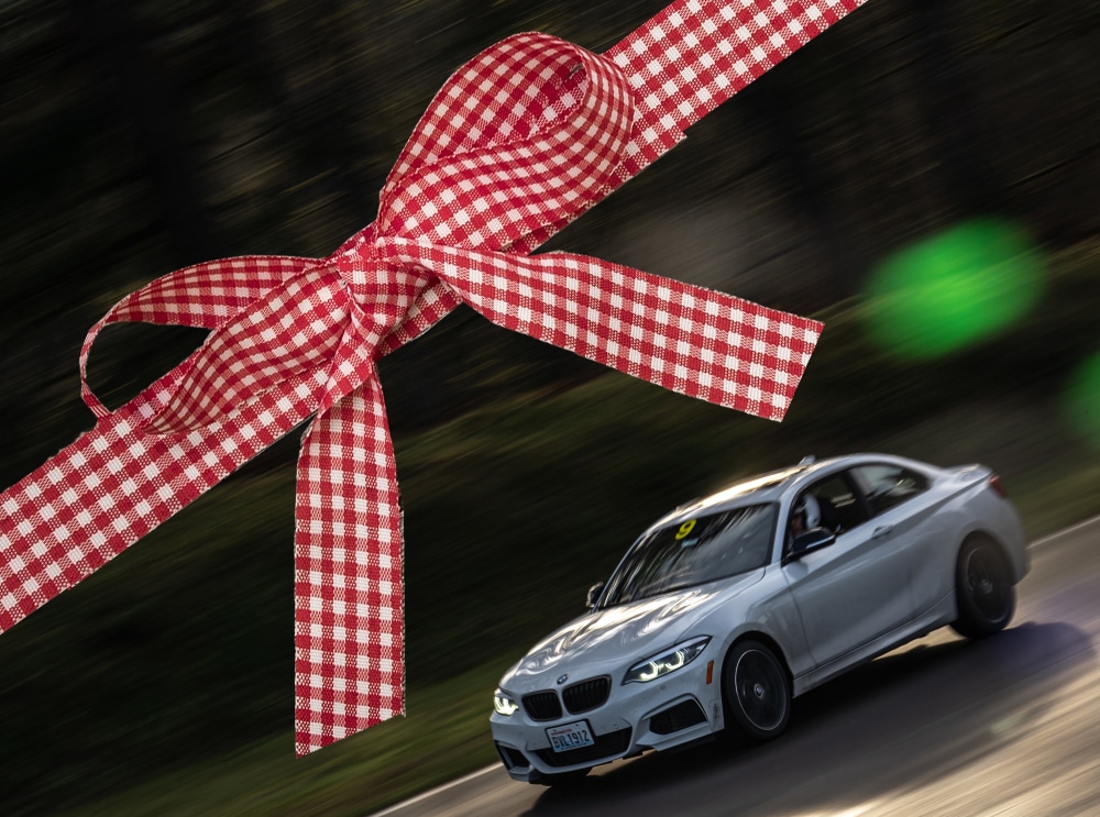 Car on track with gift ribbon