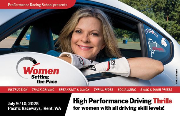Woman smiling at wheel of race car at ProFormance Women's Day