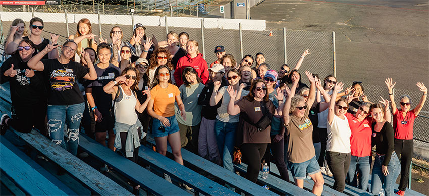 44 Women participating in ProFormance Girls Night Out posing on raceway bleachers