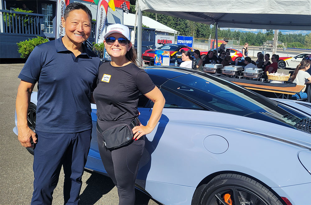John and Courtney Song pose in front of their McLaren performance car.
