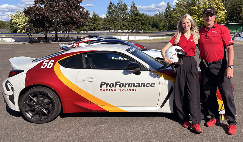 Siena Kitch in front of racecar at ProFormance with instructor Ken Hill
