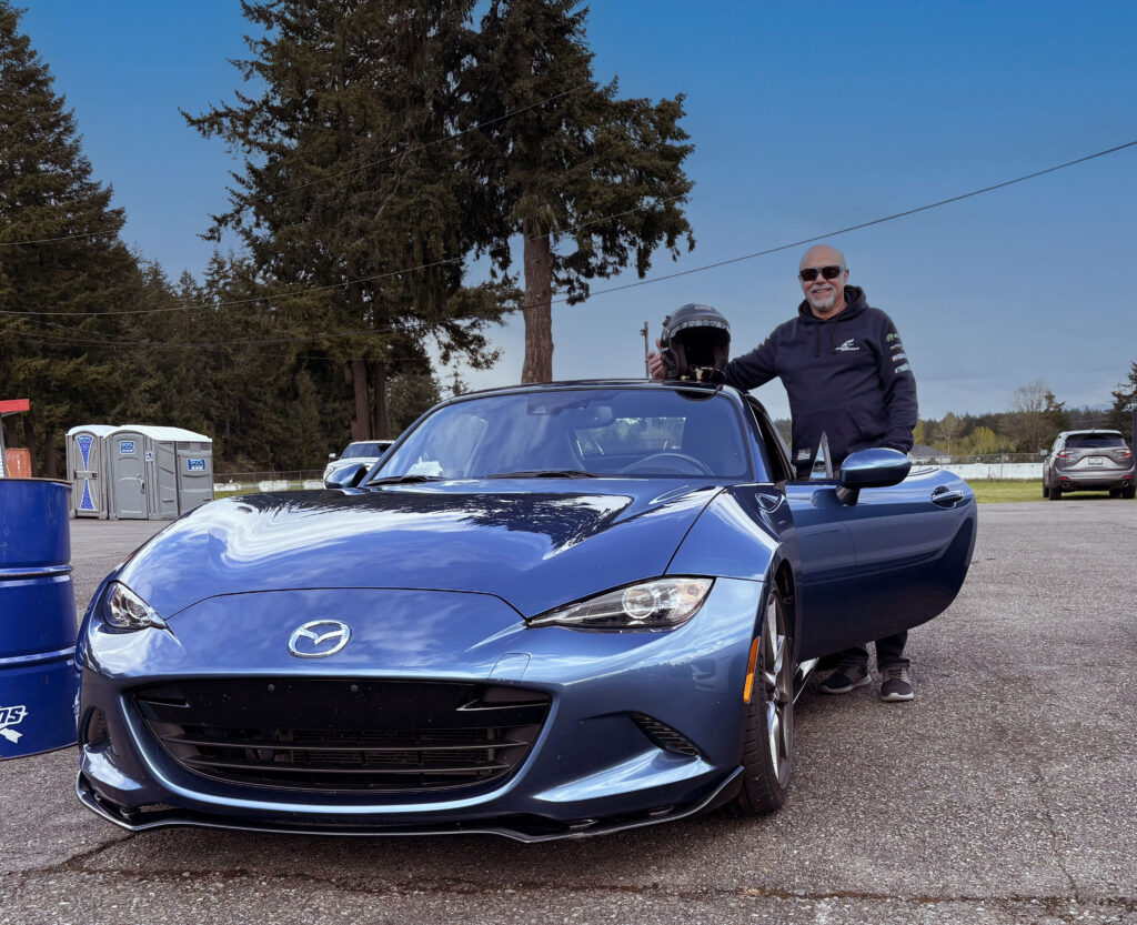 Dave Conover, winner of 2025 Person in Motorsports Award, stands by his Miata