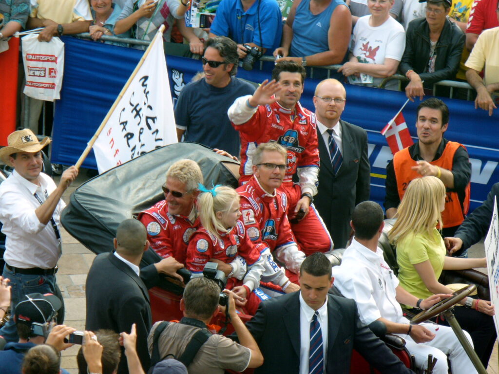 Don Kitch Jr and his daughter Siena with other drivers in vintage car at the Le Mans Drivers Parade