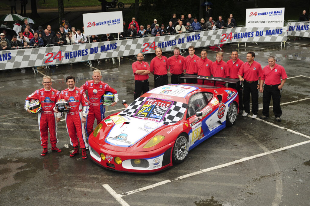 Race Drivers Joe Foster, Patrick Dempsey, and Don Kitch Jr. in front of the race car in which they competed in the 2009 Le Mans 24-hour race