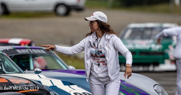 Volunteer at SOVREN vintage race helps direct cars