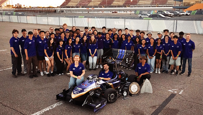 UW Formula Motorsport Team with their car posing at Michigan track