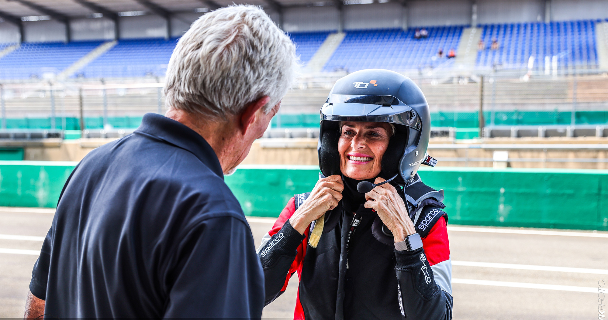 Donna Porada-Kitch at Le Mans fastening her helmet before taking to the track.